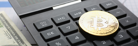 The bitcoin lies on the keyboard of the blackの写真素材