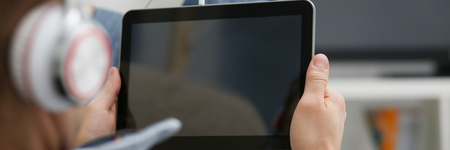 Male hand holds tablet in home