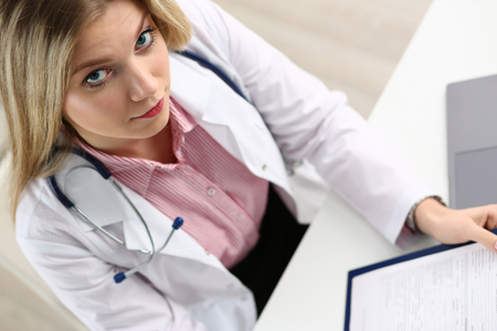 Beautiful smiling female doctor hold clipboardの写真素材