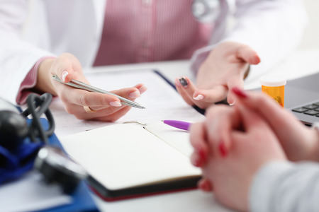 Female doctor hand hold silver penの写真素材