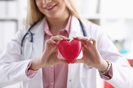 Beautiful smiling blond female doctor holdの写真素材