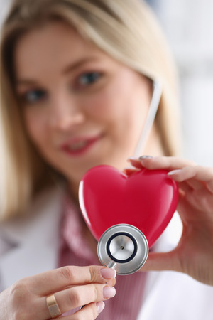 Beautiful smiling blond female doctor holdの写真素材