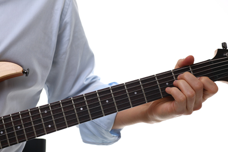 Male arms playing classic shape electric guitarの写真素材