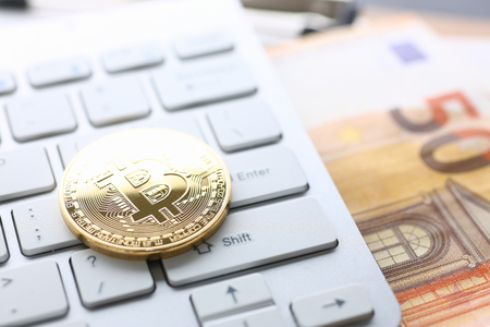 Coin crypto currency bitcoin lies on the keyboardの写真素材