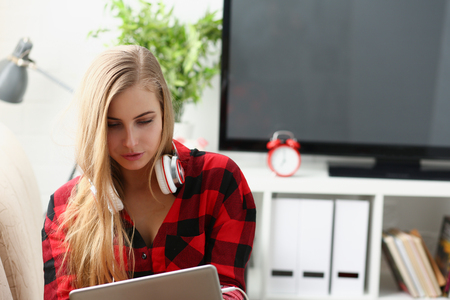 young woman surfing the internet hold laptop in arms search informationの写真素材