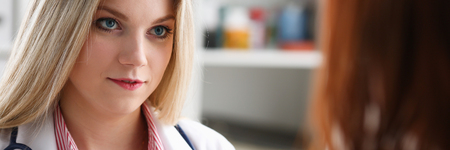 Smiling beautiful female medicine doctor explainの写真素材