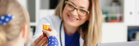 Beautiful smiling female doctor hold in arms pillの写真素材