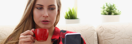 woman drinking coffe and look at laptop