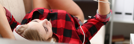 woman listen music lie on sofaの写真素材