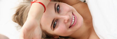 Young beautiful woman waking up in the morningの写真素材