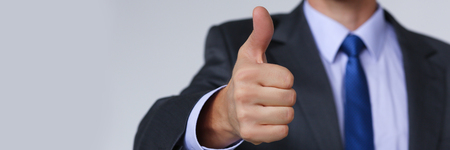 Male hand showing OK or confirm sign withの写真素材