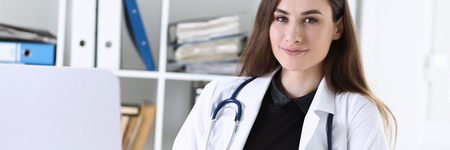 Beautiful smiling female doctor hold clipboardの写真素材