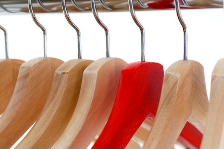 Red and wooden hanger hanging on metalの写真素材