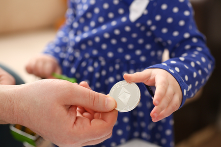 Little girl arm collecting crypto coinsの写真素材