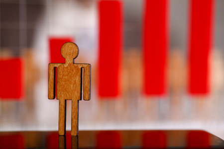 Little wooden toy figure stand outの写真素材