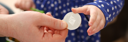 Little girl arm collecting crypto coinsの写真素材