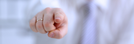 Male arm point forefinger to youの写真素材