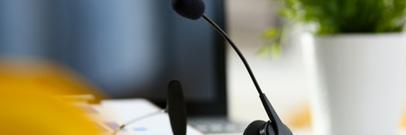 Empty remote office workplace with laptop and headsetの写真素材