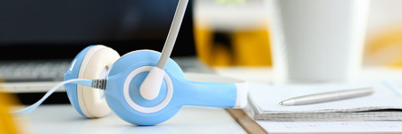 Empty remote office workplace with laptop and headsetの写真素材