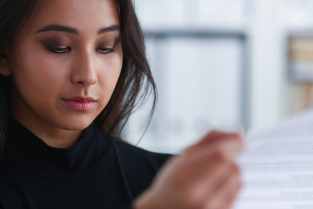 portrait of young brunette business lady study documentsの写真素材