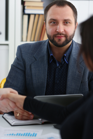young happy businessmen have meeting in office shake hands with each otherの写真素材