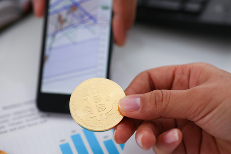 hand hold bitcoin documents smartphone closeupの写真素材