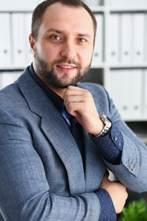 portrait of young handsome promising businessman in officeの写真素材