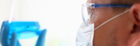 A male chemist holds test tube of glass inの写真素材
