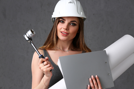 Young beautiful brunette girl wearing white helmetの写真素材