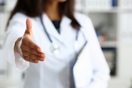 Doctor shake hand as hello with patientの写真素材