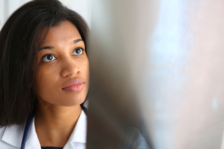 A black female doctor holding arms and looking at the x rayの写真素材