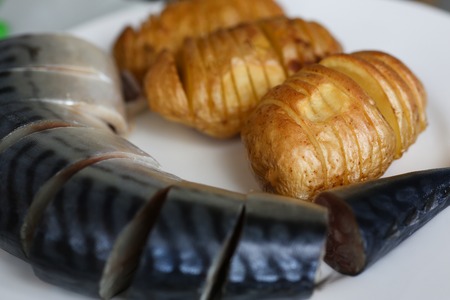 Baked golden potatoes with herring mackerelの写真素材