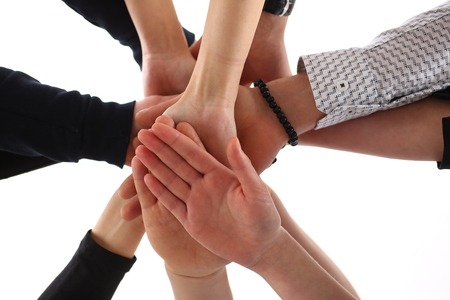 Group of people in suits crossed hands in pile for winの写真素材