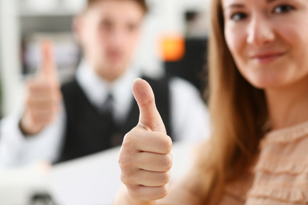 Beautiful smiling woman showing OKの写真素材