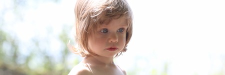 Happy little smiling child on a natural backgroundの写真素材