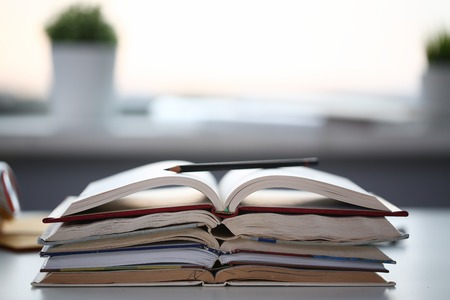 Books lie on the table in office at homeの写真素材