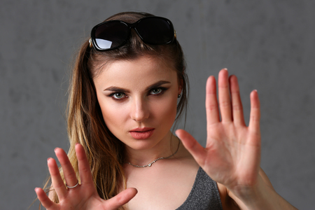Beautiful young brunette girl wearing sunglassesの写真素材