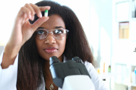Female medicine doctor hand hold jar of pillsの写真素材