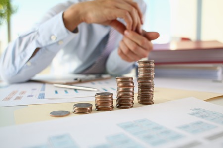 Hand businessman putting pin money
