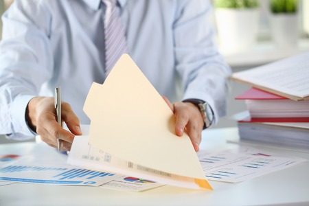 Male hands hold documents with financialの写真素材