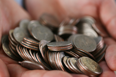 Hand businessman putting pin moneyの写真素材