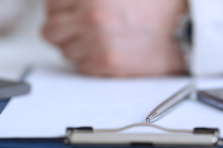 Silver pen lying on opened notebook sheet closeupの写真素材