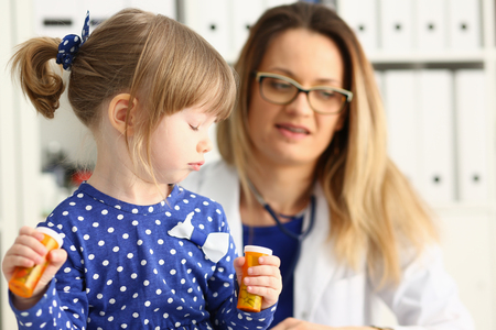 Little child with mother at pediatrician receptionの写真素材