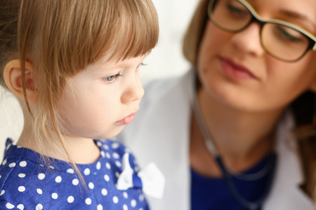 Little child with mother at pediatrician receptionの写真素材