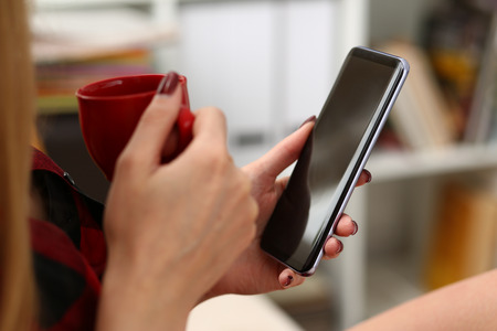 woman drinking coffe and look at laptopの写真素材