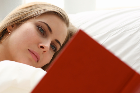 woman read book stay in bedの写真素材
