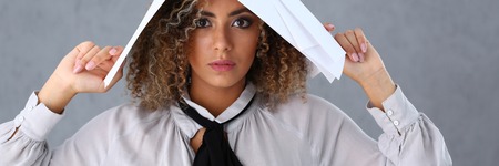 Beautiful black woman portrait. Holds paper documentsの写真素材