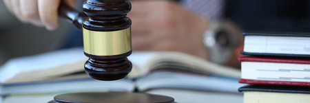 Judge holding hammer in hand lies