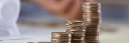 Hand businessman putting pin moneyの写真素材