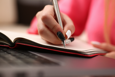 woman study hard write down information to notebookの写真素材